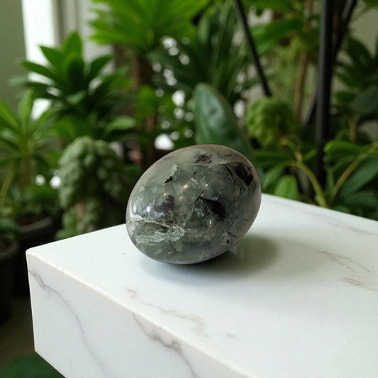 Prehnite and Epidote Egg on marble top