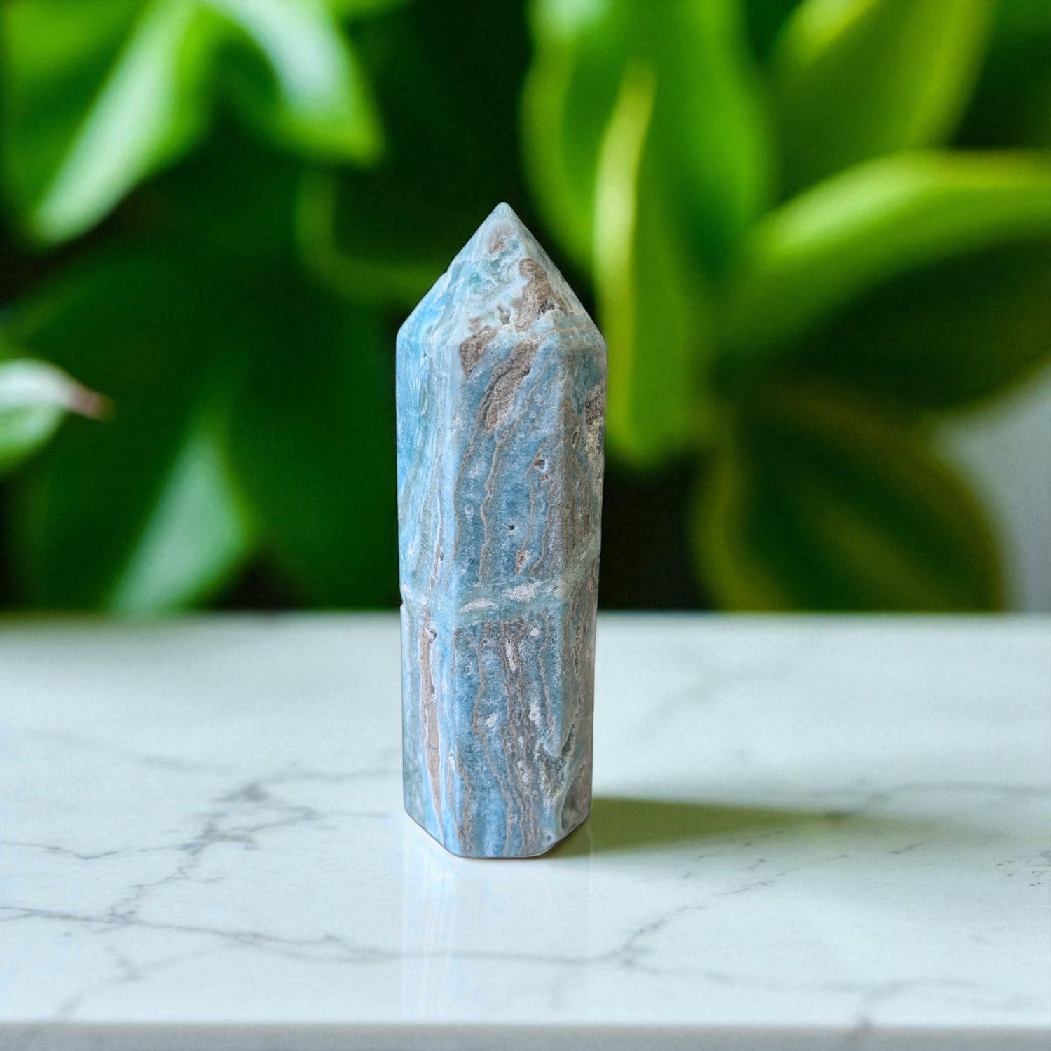 Caribbean Calcite Obelisk- 12 cm x 4cm on marble top