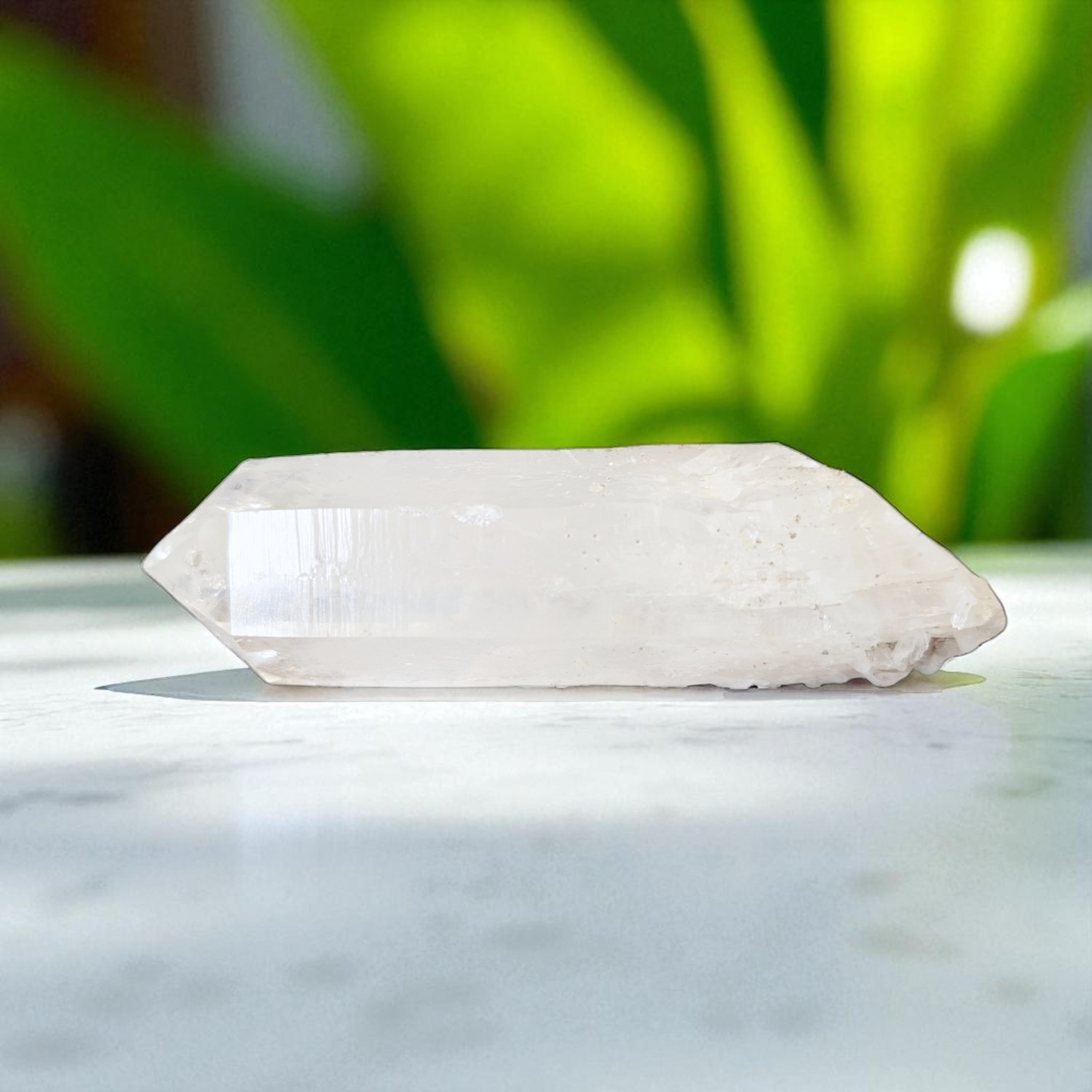 Clear Quartz Point - 12 cm x 3.5cm on marble top