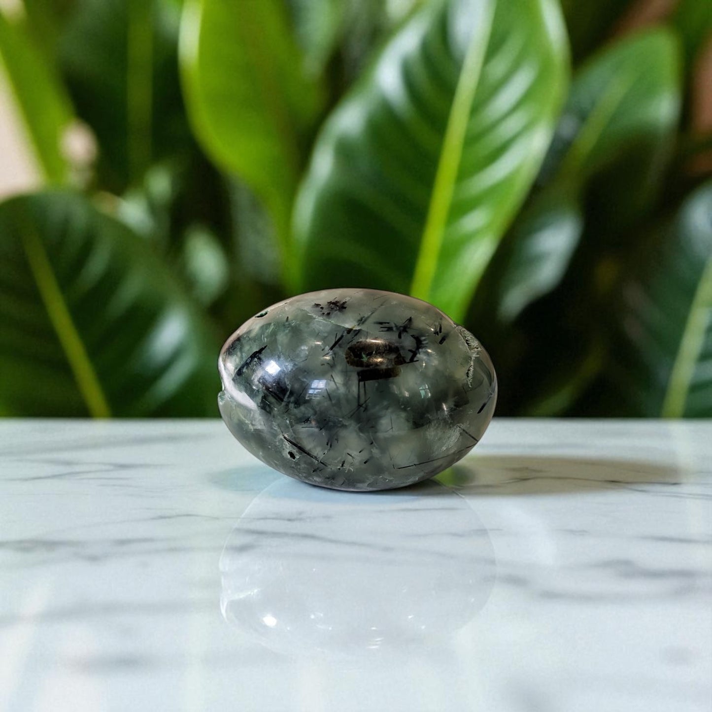 Prehnite and Epidote Egg on marble top