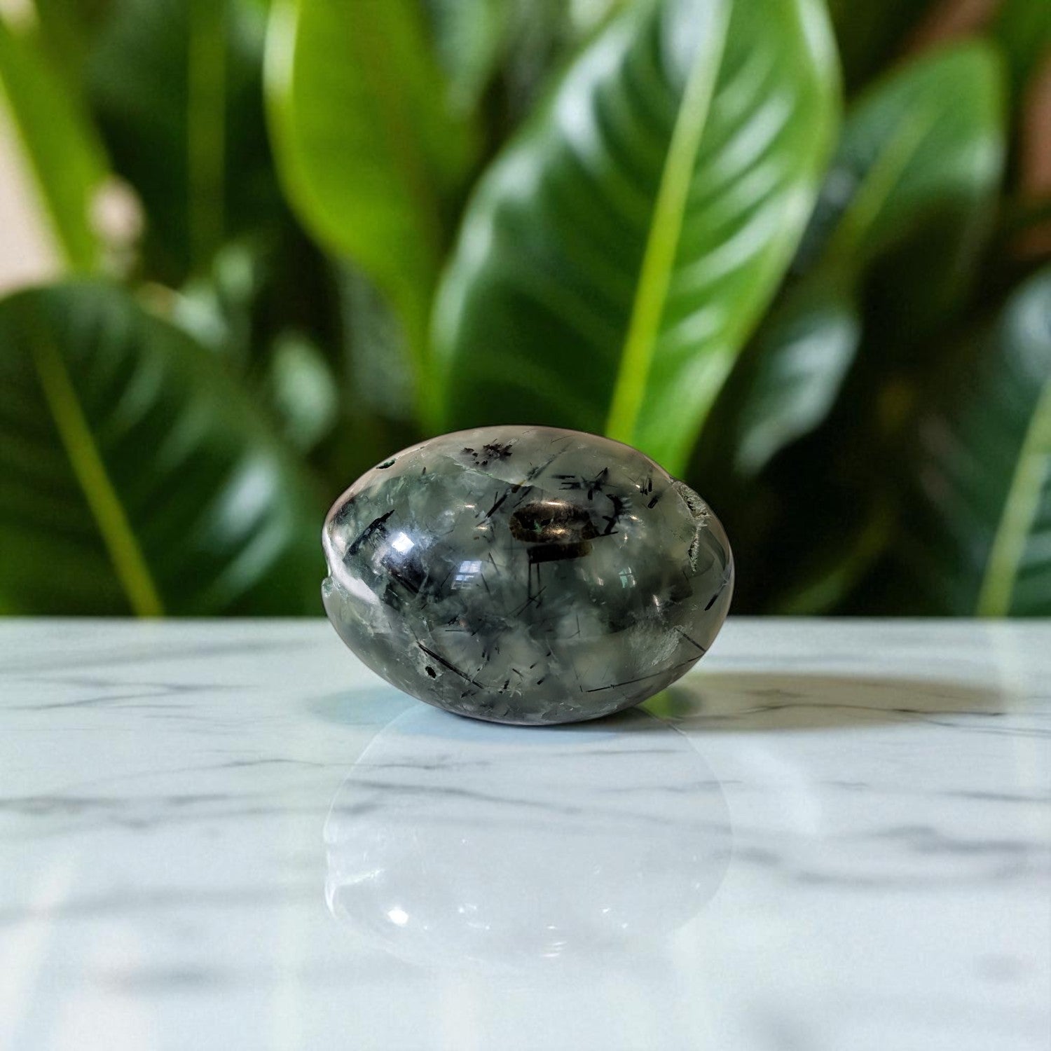 Prehnite and Epidote Egg on marble top