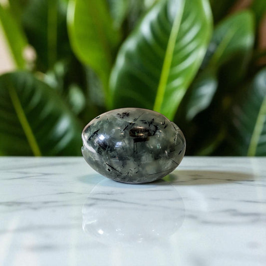Prehnite and Epidote Egg on marble top