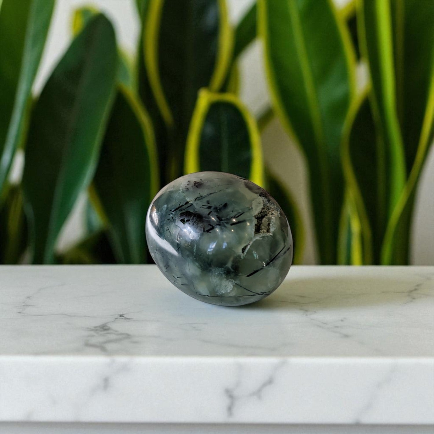 Prehnite and Epidote Egg on marble top